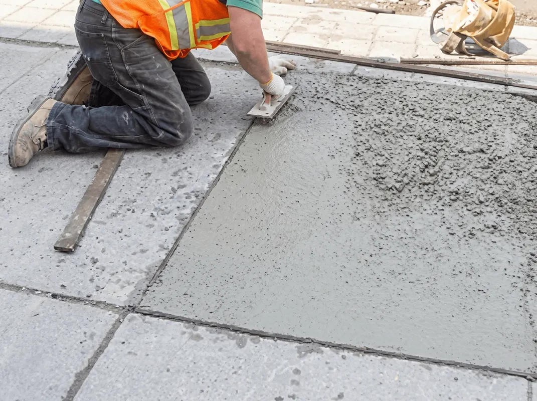 Professional repairing a concrete floor in Grand Rapids, MI